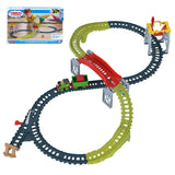 The assembled train tracks form an intricate loop with a red drop section and cargo loading area.