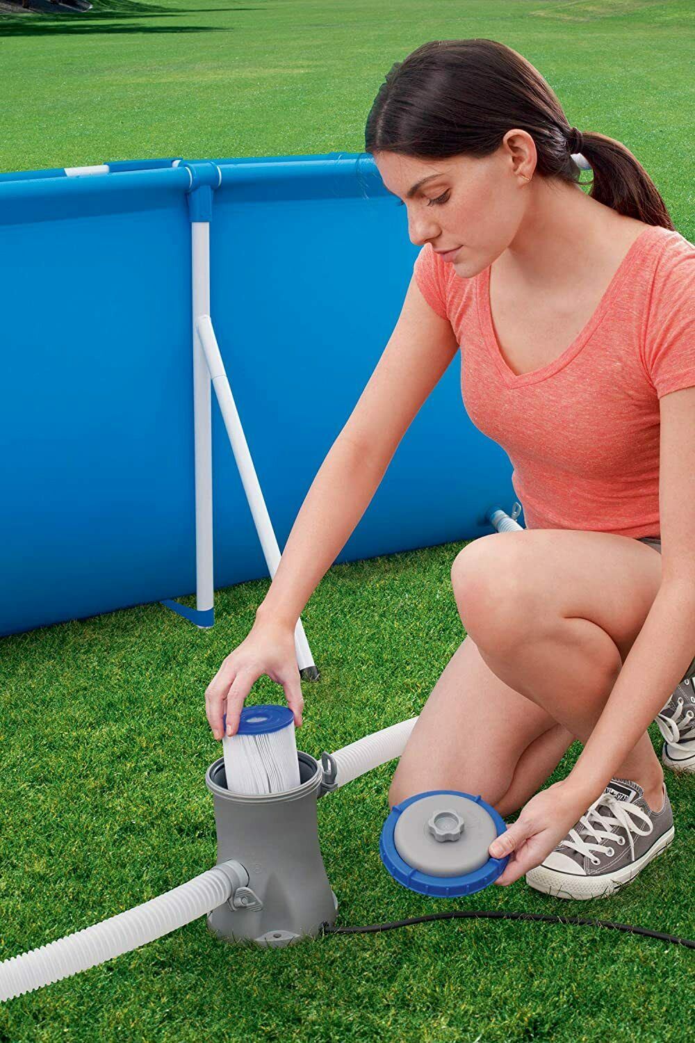 Woman standing by a portable pool pump.