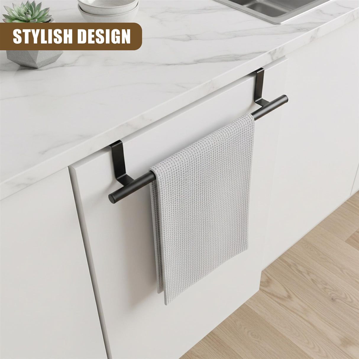 Black metal towel bar mounted on white cabinet. A folded, textured gray towel hangs from the bar.