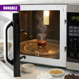 Microwave interior displays a dessert shot glass on a turntable, positioned near various small condiment bowls.