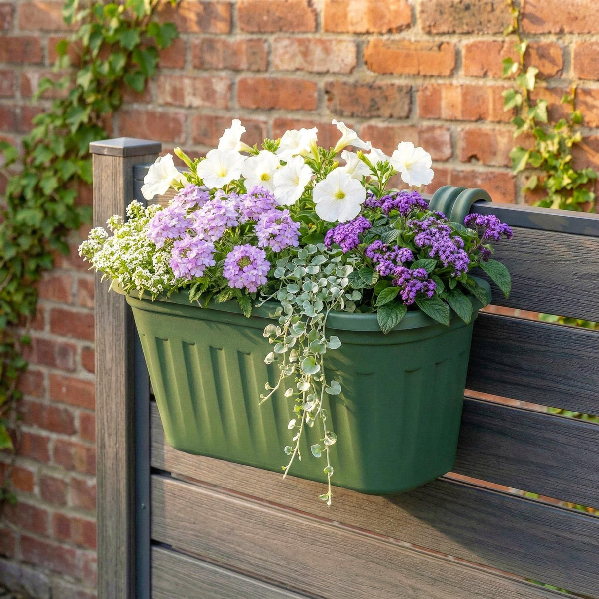 Green over fence hanging planter. Flowers in a green bucket, white flowers and purple flowers, flowers behind wooden fence. - UKBuyZone