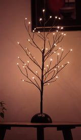 A tall tabletop Christmas tree with multi colored lights.